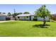 Traditional-style home with lush green grass, mature shade tree, and neutral-colored exterior at 215 W Ruth Ave, Phoenix, AZ 85021