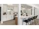 Modern kitchen with marble counters, white cabinetry, an island with counter seating, and stainless steel appliances at 215 W Ruth Ave, Phoenix, AZ 85021