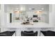 Bright modern kitchen island with marble countertop, stylish lighting, and seating for casual dining at 215 W Ruth Ave, Phoenix, AZ 85021