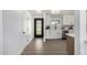 Bright kitchen with modern appliances, white cabinetry, stainless steel appliances, wood floor and a black paneled glass door at 215 W Ruth Ave, Phoenix, AZ 85021