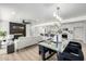 Bright open-concept living room and kitchen featuring modern design, fireplace and glass dining table with seating at 215 W Ruth Ave, Phoenix, AZ 85021