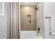 Well-lit shower space showcasing modern fixtures, a built-in shelf, and elegant tile work at 215 W Ruth Ave, Phoenix, AZ 85021
