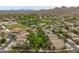 High-angle shot of homes in a desert neighborhood featuring parks and a verdant green landscape at 2221 W Calle De Las Estrella Way, Phoenix, AZ 85085