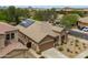 Aerial view of home with a desert landscape, solar panels, and a multi-car driveway in a residential area at 2221 W Calle De Las Estrella Way, Phoenix, AZ 85085