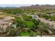 Scenic aerial view of the homes in a vibrant desert community with verdant landscaping and community park at 2221 W Calle De Las Estrella Way, Phoenix, AZ 85085