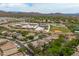 Expansive aerial view of a neighborhood near a school, boasting lush greenery and mountain views at 2221 W Calle De Las Estrella Way, Phoenix, AZ 85085