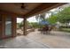 Covered back patio with space for entertaining and a view of the built-in BBQ and patio furniture at 2221 W Calle De Las Estrella Way, Phoenix, AZ 85085