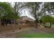 Large backyard with outdoor seating and mature landscaping, providing a serene and private outdoor experience at 2221 W Calle De Las Estrella Way, Phoenix, AZ 85085