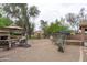 Well-maintained backyard with outdoor fireplace, lounge seating, and desert landscaping, perfect for entertaining at 2221 W Calle De Las Estrella Way, Phoenix, AZ 85085