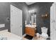 Cozy bathroom featuring a wooden vanity, toilet, and bathtub combination with a neutral color scheme at 2221 W Calle De Las Estrella Way, Phoenix, AZ 85085