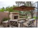 Outdoor fireplace with a seating area, providing a cozy and inviting space for gatherings and relaxation at 2221 W Calle De Las Estrella Way, Phoenix, AZ 85085