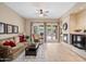 A comfortable living room area with a fireplace and a view of the patio at 2221 W Calle De Las Estrella Way, Phoenix, AZ 85085