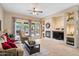 Bright living room featuring a fireplace, TV, and access to the outdoor patio at 2221 W Calle De Las Estrella Way, Phoenix, AZ 85085