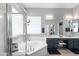 Bright bathroom featuring corner bathtub, walk-in shower, double vanity, and white and black cabinets at 2221 W Calle De Las Estrella Way, Phoenix, AZ 85085