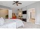 Spacious main bedroom boasts plush carpet, ceiling fan, and adjoins other rooms in the house at 2221 W Calle De Las Estrella Way, Phoenix, AZ 85085