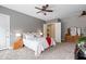 Comfortable main bedroom features neutral paint, plush carpet, and doorway leading to bathroom at 2221 W Calle De Las Estrella Way, Phoenix, AZ 85085