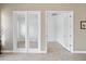 Bright home office with white trim, glass doors, wood floors, and plenty of workspace at 2221 W Calle De Las Estrella Way, Phoenix, AZ 85085