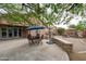 Outdoor patio with dining set, lounge area, stone accents, and direct access to the home's interior at 2221 W Calle De Las Estrella Way, Phoenix, AZ 85085