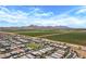 This aerial view shows houses surrounded by verdant fields, nestled in a well-maintained community at 22476 E Indiana Ave, Queen Creek, AZ 85142