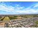 Stunning aerial perspective of a suburban landscape, highlighting homes, farms, and a vast open space at 22476 E Indiana Ave, Queen Creek, AZ 85142