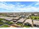 This aerial view showcases houses with well-kept lawns and backyards, nestled in a friendly neighborhood at 22476 E Indiana Ave, Queen Creek, AZ 85142