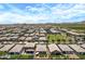 This aerial view shows a neighborhood with tidy homes, showcasing landscaping and community amenities at 22476 E Indiana Ave, Queen Creek, AZ 85142