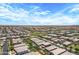 This aerial shot displays an expansive community with houses featuring well-maintained landscaping at 22476 E Indiana Ave, Queen Creek, AZ 85142