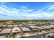 Expansive aerial view of a residential neighborhood showcasing single-Gathering homes and scenic landscaping at 22476 E Indiana Ave, Queen Creek, AZ 85142