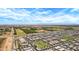 Panoramic aerial view of a residential community with lush greenery, nearby farmland, and a major roadway at 22476 E Indiana Ave, Queen Creek, AZ 85142