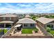 An expansive backyard featuring lush artificial turf, patio area, and a charming patio furniture setup at 22476 E Indiana Ave, Queen Creek, AZ 85142