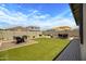 Lush backyard boasts artificial turf, patio areas for dining and lounging, and a well-maintained landscape at 22476 E Indiana Ave, Queen Creek, AZ 85142