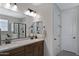 Bathroom featuring double sinks, modern vanity, and separate glass-enclosed shower, designed for comfort at 22476 E Indiana Ave, Queen Creek, AZ 85142
