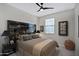 Cozy bedroom with a statement headboard, plush bedding, and a ceiling fan at 22476 E Indiana Ave, Queen Creek, AZ 85142