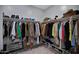 Well-organized walk-in closet with shelving, hanging rods, and ample storage space for clothes and accessories at 22476 E Indiana Ave, Queen Creek, AZ 85142