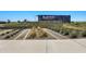 An attractive community entrance sign with manicured landscaping at 22476 E Indiana Ave, Queen Creek, AZ 85142