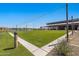 Expansive green lawn area within the community, perfect for outdoor activities and relaxation at 22476 E Indiana Ave, Queen Creek, AZ 85142