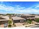 Attractive single-Gathering home with a well-maintained lawn, paved driveway, and a spacious two-car garage at 22476 E Indiana Ave, Queen Creek, AZ 85142