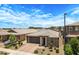 Beautifully landscaped single-Gathering home featuring a brick-paved driveway and a two-car garage at 22476 E Indiana Ave, Queen Creek, AZ 85142