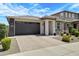 Beautiful single-story home with a two-car garage and desert landscaping, perfect for low-maintenance living at 22476 E Indiana Ave, Queen Creek, AZ 85142