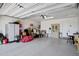 Spacious two-car garage with epoxy flooring, storage cabinets, and ample room for parking and projects at 22476 E Indiana Ave, Queen Creek, AZ 85142