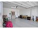 Well-lit two-car garage featuring epoxy flooring, storage solutions, and abundant open space at 22476 E Indiana Ave, Queen Creek, AZ 85142