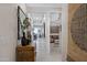 Inviting hallway featuring neutral tones, tiled floors, and glimpses of the living and dining areas at 22476 E Indiana Ave, Queen Creek, AZ 85142