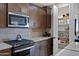 Kitchen with stainless steel appliances, microwave, and full walk-in pantry at 22476 E Indiana Ave, Queen Creek, AZ 85142