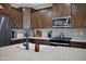 Kitchen featuring stainless appliances, granite counters, and wooden cabinetry at 22476 E Indiana Ave, Queen Creek, AZ 85142