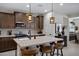 Kitchen with stainless steel appliances, modern countertops, and stylish pendant lighting at 22476 E Indiana Ave, Queen Creek, AZ 85142
