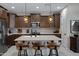 Kitchen island with pendant lighting and breakfast bar seating, plus stainless appliances at 22476 E Indiana Ave, Queen Creek, AZ 85142