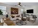 Comfortable living room with stylish seating, decorative pillows, and a ceiling fan at 22476 E Indiana Ave, Queen Creek, AZ 85142