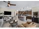 Open-concept living room and kitchen with center island and stainless steel appliances at 22476 E Indiana Ave, Queen Creek, AZ 85142