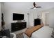 Bright bedroom with a comfortable bed, modern dresser, and a ceiling fan, offering a serene atmosphere at 22476 E Indiana Ave, Queen Creek, AZ 85142