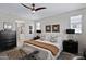 Elegant bedroom with a well-dressed bed, coordinating nightstands, and ensuite bathroom with shower at 22476 E Indiana Ave, Queen Creek, AZ 85142